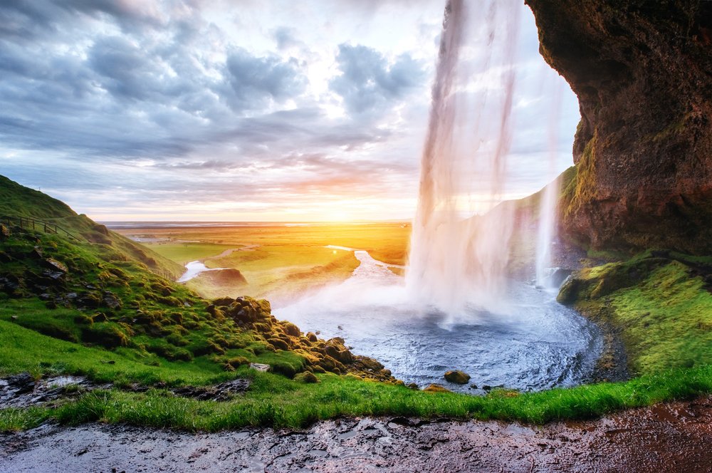 Seljalandsfoss, Cloud, Water, Sky, Plant, Water resources, Natural landscape, Mountain, Sunlight